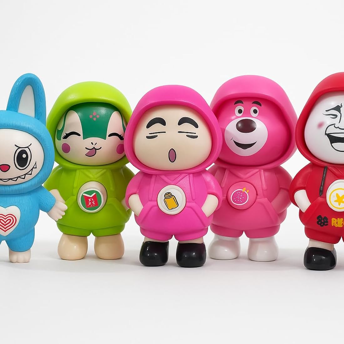 Five colorful cartoon character figurines with different designs on a white background