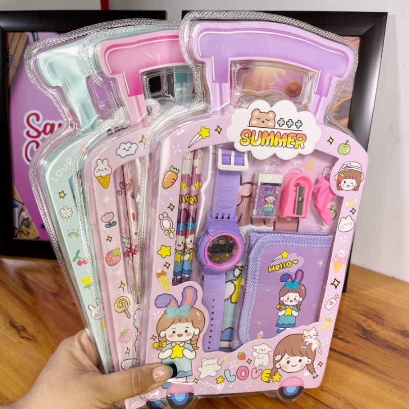 Packaged children's watch and accessories with cartoon design on a wooden surface.