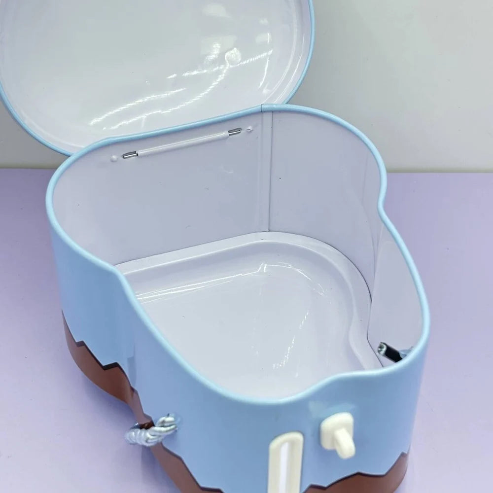 Blue pet carrier with open lid on a light purple surface