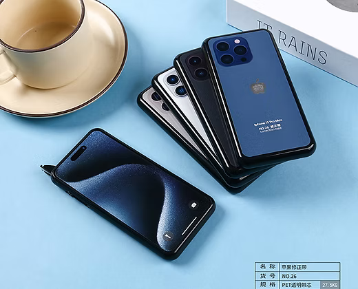 Stack of smartphones on a blue surface with a cup and saucer in the background